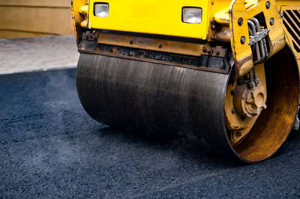 Asphalt being rolled flat